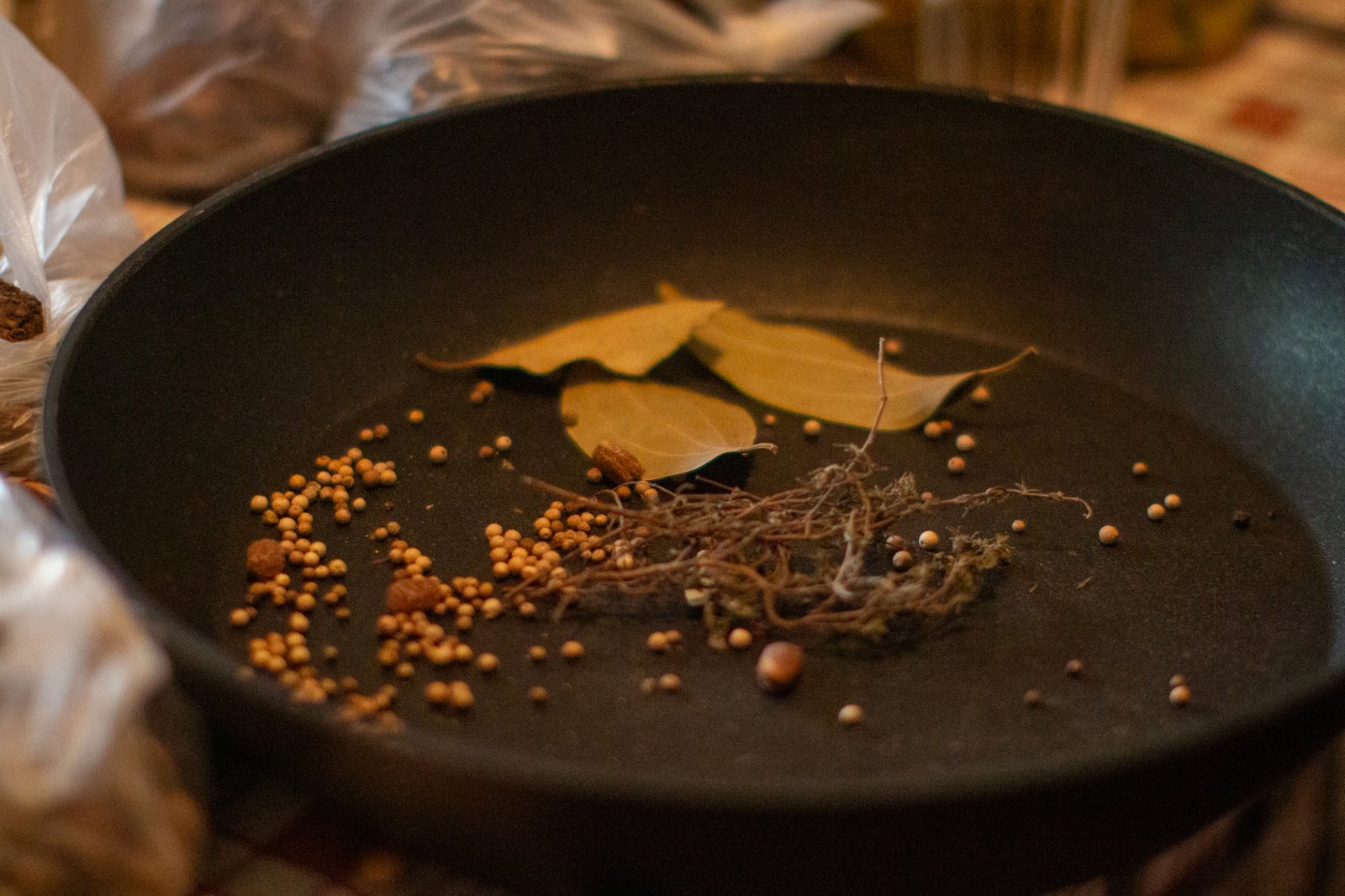 Whole spices arranged in a cooking pan